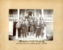 Black and white photograph of the 1899-1900 Special and P.G. students posing on the porch of Old North, wearing coats and ties, with Rev. Whitney
