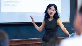 A faculty member lectures in a classroom