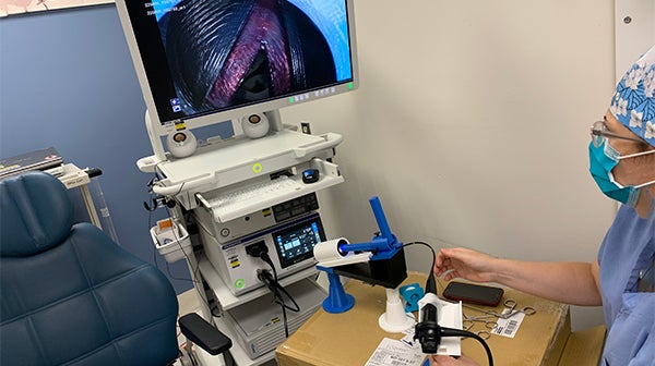 Microlaryngeal surgery tool being used by medical student