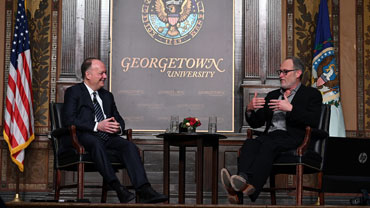 Georgetown President John DeGioia (left) and director Jon Turteltaub on stage at the 2023 Tanous Lecture.