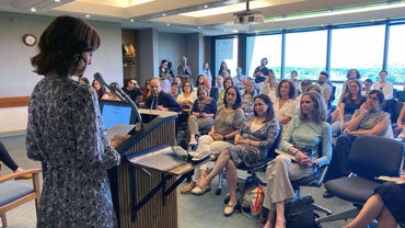 Irene Vallejo speaking to a crowded room