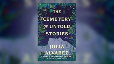 Book cover for "The Cemetery of Untold Stories" by Julia Alvarez with a woman laying on grass looking at the night sky.