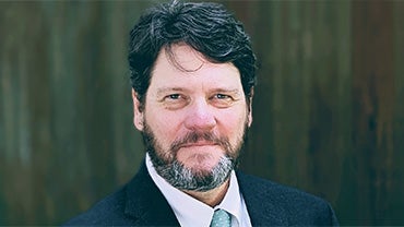 Headshot of Joe Williams, a middle-aged white man with dark hair and a beard.