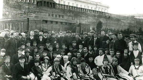 black and white image of a group of people sitting for a photo. 