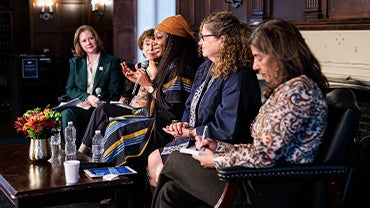 a panel of women speak at a symposium in Copley Formal Lounge