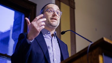 Ben Casselman addresses a crowd at a podium