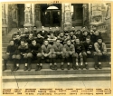 a sepia photograph of the Team of 1909 sitting on the steps of healy hall. the team members' names have been written in ink below the photograph.
