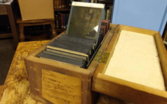 Some of Brosnan's glass plate lantern slides in its original storage box.