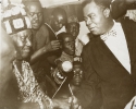 Louis Armstrong shakes hands with a local African chief