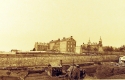 Detail from a photograph of the completed college wall with shanties below on Warren (Thirty-Seventh) Street