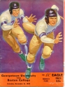 a program for the 1940 Georgetown versus Boston College game. the program depicts an illustration of two football players against a solid purple background, with black text at the bottom of the image against a solid red background.
