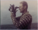 Photograph of Michael Richey taking a sextant reading on an ocean-racing voyage