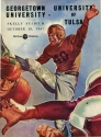 the cover of a Georgetown vs University of Tulsa Game Program, 1947. the cover features a title and an illustration of football players.