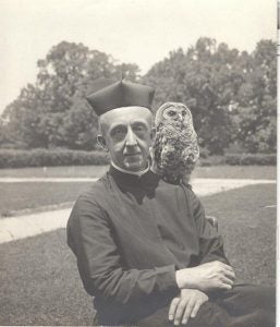 William H. McClellan, S.J. with owl on his shoulder