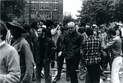 Black and white photograph of a crowd protesters inside the main gates