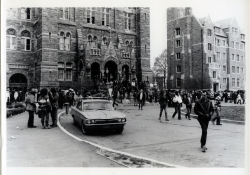 Black and white photograph of protesters in Healy Circle and on the Healy Hall steps
