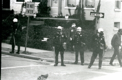 Black and white photograph of police in riot gear on the northeast corner of 37th and O streets