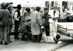 Black and white photograph of a student medic treating an injured protester