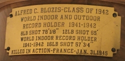 Photograph of plaque on shot display stand listing Blozis's world records