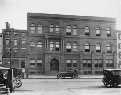 Black and white photograph of  Law School building with motorcars parked outside