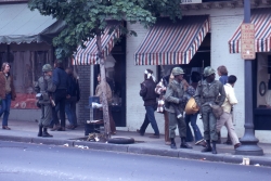 Color photo of troops on Wisconsin Avenue