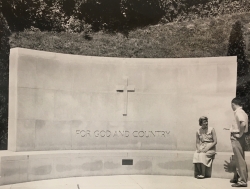 Black and white photograph of a man and a women next to the war memorial