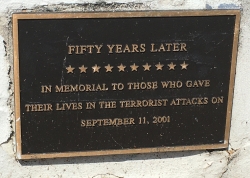 Photograph of plaque which reads Fifty years later - In memorial to those who gave their lives in the terrorist attacks on September 11, 2001