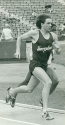 Black and white photo of John Gregorek in a GU uniform competing in a race