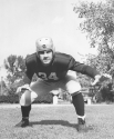 a black and white portrait of Augie Lio, Right Guard and Kicker, 1938-1941, in football uniform
