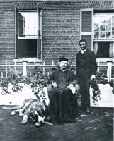 A black and white photograph of Hoia the dog with his owner Rev. William H. Carroll, S.J. and Tom.
