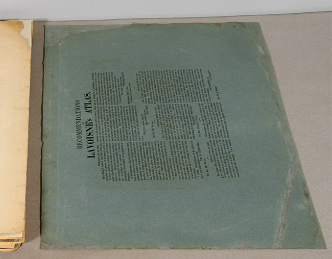 green book wrapper with printed text after conservation treatment