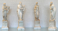 Four small alabaster statues, showing left to right: Erato, Apollo, Euterpe, and Terpsichore