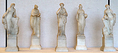 Five small alabaster statues, showing left to right: Melpomene, Calliope, Polyhymnia, Urania, and Talia