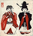 Two dolls wearing red and back costumes