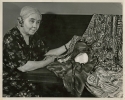 Louise Boyer with a display of silk fabrics hand painted by herself and her daughter