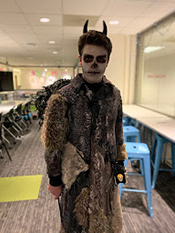Josh Mauss posing with his Halloween costume made in the Maker Hub