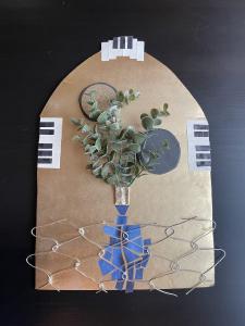 Multi-media collage on poster board; wire, magazine clippings, faux flowers.