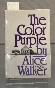 Book cover, purple font, house and trees