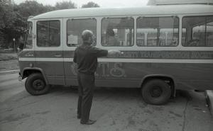 Photograph of Father Larry Madden blessing the buses