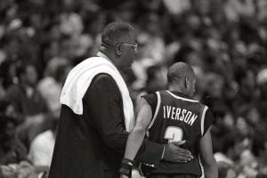 B X W photo of coach wearing white towel tapping back of player Iverson "3"