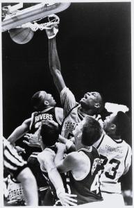 B X W photo of Georgetown Center Dikembe Mutombo dunk over 4 players including Mourning "33" in foreground