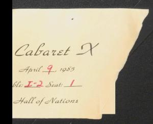 Torn ticket with the table and seat number handwritten in red