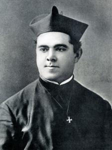 John O'Conor, a young priest wearing robes and a Jesuit biretta, with a small cross hanging around his neck