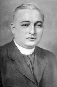 Leo Andries, a priest with short hair wearing a dark jacket and white collar