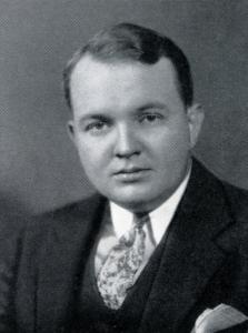 Mark Stumpf, wearing a suit, vest and necktie, and a pocket square in his jacket pocket