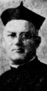 A blurry photograph of Patrick Cormican, an older priest wearing glasses and dressed in a dark coat and white collar with Jesuit biretta