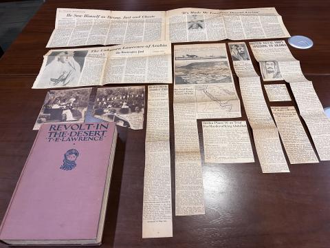 Amanda's copy of Revolt in the Desert on display with the newspaper clippings she found in the book