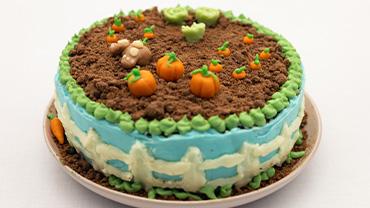 Chocolate cake with a bunny ornament digging through the chocolate crumbles.