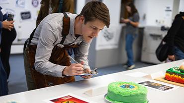 A judge inspects one of the submitted items.