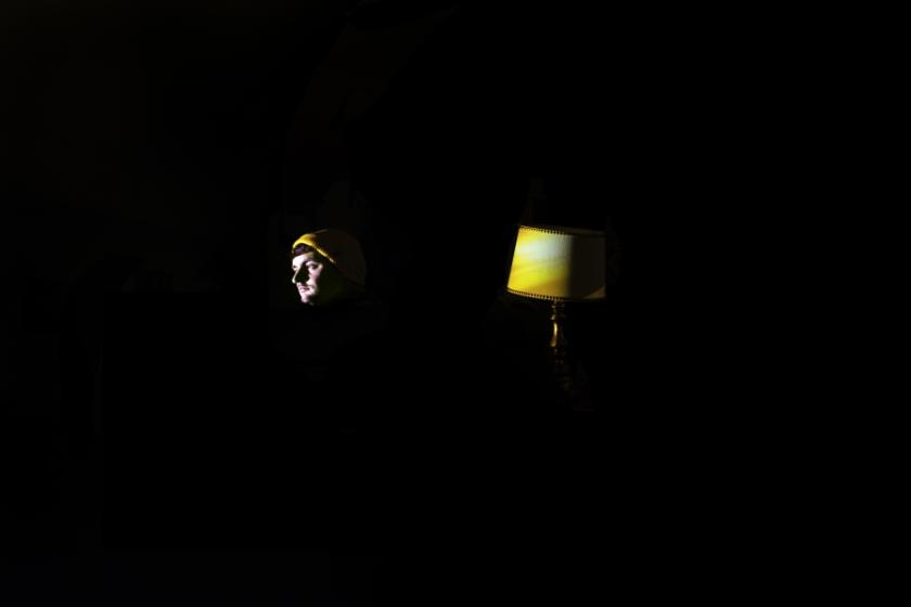 A man in a yellow hat and a lamp